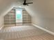 Spacious room with custom built-in shelving, carpet floors and a bright window at 80 Water Willow Ln, Zebulon, NC 27597