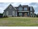 Charming home with a well-maintained lawn and inviting covered porch with decorative wooden shutters at 80 Water Willow Ln, Zebulon, NC 27597
