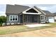Gray two-story home with screened-in porch, brick base and manicured lawn at 80 Water Willow Ln, Zebulon, NC 27597