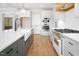 This bright kitchen features white cabinets, stainless steel appliances, and hardwood floors at 80 Water Willow Ln, Zebulon, NC 27597