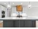 Close-up of kitchen island shows quartz countertop, dark cabinetry and a modern black faucet at 80 Water Willow Ln, Zebulon, NC 27597