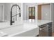 Farmhouse sink with modern faucet on an island and stainless steel appliances at 80 Water Willow Ln, Zebulon, NC 27597