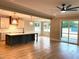 Open-concept living area with hardwood floors, island seating, and a sliding glass door to outdoor living at 80 Water Willow Ln, Zebulon, NC 27597