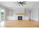 Living room features hardwood floors, a fireplace with custom built-ins and sliding glass doors at 80 Water Willow Ln, Zebulon, NC 27597