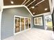 Covered patio offers a ceiling fan, recessed lights, and sliding glass doors at 80 Water Willow Ln, Zebulon, NC 27597