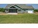 Beautiful rear exterior with a screened-in porch and a spacious, green lawn at 80 Water Willow Ln, Zebulon, NC 27597
