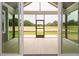 Inviting screened porch with ample space and views of the green yard, perfect for outdoor enjoyment at 80 Water Willow Ln, Zebulon, NC 27597