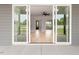 Wide sliding glass doors reveal the living room with a ceiling fan and recessed lighting at 80 Water Willow Ln, Zebulon, NC 27597