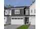Charming townhome featuring a gray and white exterior, brick accents, and a two-car garage at 8937 Kennebec Crossing Dr, Angier, NC 27501