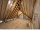 Unfinished attic with plywood flooring, weather barrier and visible rafter and truss roof support system at 90 Water Willow Ln, Zebulon, NC 27597