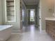 Luxury bathroom with a soaking tub, glass enclosed shower and lots of storage at 90 Water Willow Ln, Zebulon, NC 27597