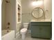 Bathroom with olive green vanity, bronze fixtures, a tub and tiled floors at 90 Water Willow Ln, Zebulon, NC 27597