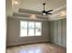 Spacious bedroom with tray ceiling, recessed lighting, and a large window view at 90 Water Willow Ln, Zebulon, NC 27597