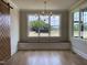 Bright dining room features a window seat, chandelier, and attractive sliding barn door at 90 Water Willow Ln, Zebulon, NC 27597