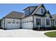 Charming home with three-car garage, white siding, and a well-manicured lawn, providing a warm and inviting curb appeal at 90 Water Willow Ln, Zebulon, NC 27597