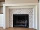 Close-up of fireplace with herringbone marble surround at 90 Water Willow Ln, Zebulon, NC 27597