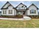 Beautiful home with charming wood shutters and manicured lawn at 90 Water Willow Ln, Zebulon, NC 27597