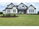 Stunning two-story home with light siding, brown shutters, manicured lawn and attractive landscaping at 90 Water Willow Ln, Zebulon, NC 27597