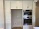 Close up view of kitchen appliances featuring a microwave and oven at 90 Water Willow Ln, Zebulon, NC 27597