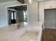 Close-up of kitchen island featuring a farmhouse sink and marble countertop at 90 Water Willow Ln, Zebulon, NC 27597