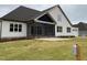Rear exterior of home with a screened porch and manicured lawn at 90 Water Willow Ln, Zebulon, NC 27597