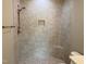 Walk-in shower features tiled walls, a built-in seat, and bronze hardware at 90 Water Willow Ln, Zebulon, NC 27597