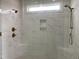 Elegant walk-in shower with dual shower heads, marble tile, and built-in niche at 90 Water Willow Ln, Zebulon, NC 27597