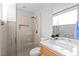 Modern bathroom featuring a glass shower, and a light hardwood vanity at 9021 Albatross Ct, Raleigh, NC 27613
