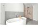 Elegant bathroom features a freestanding tub, glass shower, and contemporary finishes at 9021 Albatross Ct, Raleigh, NC 27613