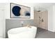 Modern bathroom features a freestanding tub, glass-enclosed shower, and stylish decor at 9021 Albatross Ct, Raleigh, NC 27613