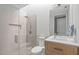 Modern bathroom featuring a glass shower, and a light hardwood vanity at 9021 Albatross Ct, Raleigh, NC 27613