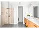 Modern bathroom featuring glass shower, double vanity, and sleek, stylish design at 9021 Albatross Ct, Raleigh, NC 27613