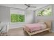 Bright bedroom with a large window, ceiling fan, and hardwood flooring at 9021 Albatross Ct, Raleigh, NC 27613