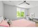 Cozy bedroom with a ceiling fan, large window, and a dedicated study space at 9021 Albatross Ct, Raleigh, NC 27613