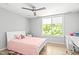Bright bedroom with a large window, ceiling fan, and hardwood flooring at 9021 Albatross Ct, Raleigh, NC 27613