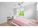 Bright bedroom with a large window, ceiling fan, and hardwood flooring at 9021 Albatross Ct, Raleigh, NC 27613