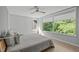 Light-filled bedroom with large windows offers tree views and a cozy, stylish setting at 9021 Albatross Ct, Raleigh, NC 27613