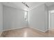 Neutral bedroom featuring light hardwood floors, two large windows and overhead lighting at 9021 Albatross Ct, Raleigh, NC 27613