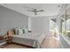 Comfortable bedroom features a modern ceiling fan, large windows, and stylish decor at 9021 Albatross Ct, Raleigh, NC 27613