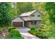 Contemporary home featuring a stylish gray brick facade, clean lines, and integrated two car garage at 9021 Albatross Ct, Raleigh, NC 27613