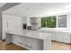 Modern kitchen featuring white cabinets, stainless steel appliances, and a large center island at 9021 Albatross Ct, Raleigh, NC 27613