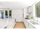 Bright kitchen with white cabinets, stainless steel appliances and a large island with backyard access at 9021 Albatross Ct, Raleigh, NC 27613