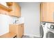 Functional laundry room with ample storage and modern washer/dryer at 9021 Albatross Ct, Raleigh, NC 27613