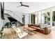 Spacious living room with floor-to-ceiling windows and a modern staircase at 9021 Albatross Ct, Raleigh, NC 27613