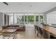 Bright open living room with floor-to-ceiling windows and views of the outdoor patio at 9021 Albatross Ct, Raleigh, NC 27613