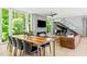 Modern living room featuring a fireplace, grand piano, and a contemporary staircase at 9021 Albatross Ct, Raleigh, NC 27613