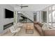 Open living area showcasing a fireplace, staircase, grand piano, and modern furniture at 9021 Albatross Ct, Raleigh, NC 27613