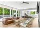 Bright open-concept living space with floor-to-ceiling windows and hardwood floors at 9021 Albatross Ct, Raleigh, NC 27613