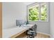 Bright office space featuring a sleek desk and chair with views of lush greenery at 9021 Albatross Ct, Raleigh, NC 27613