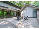 Modern patio with outdoor seating, fire pit, and large folding glass doors at 9021 Albatross Ct, Raleigh, NC 27613